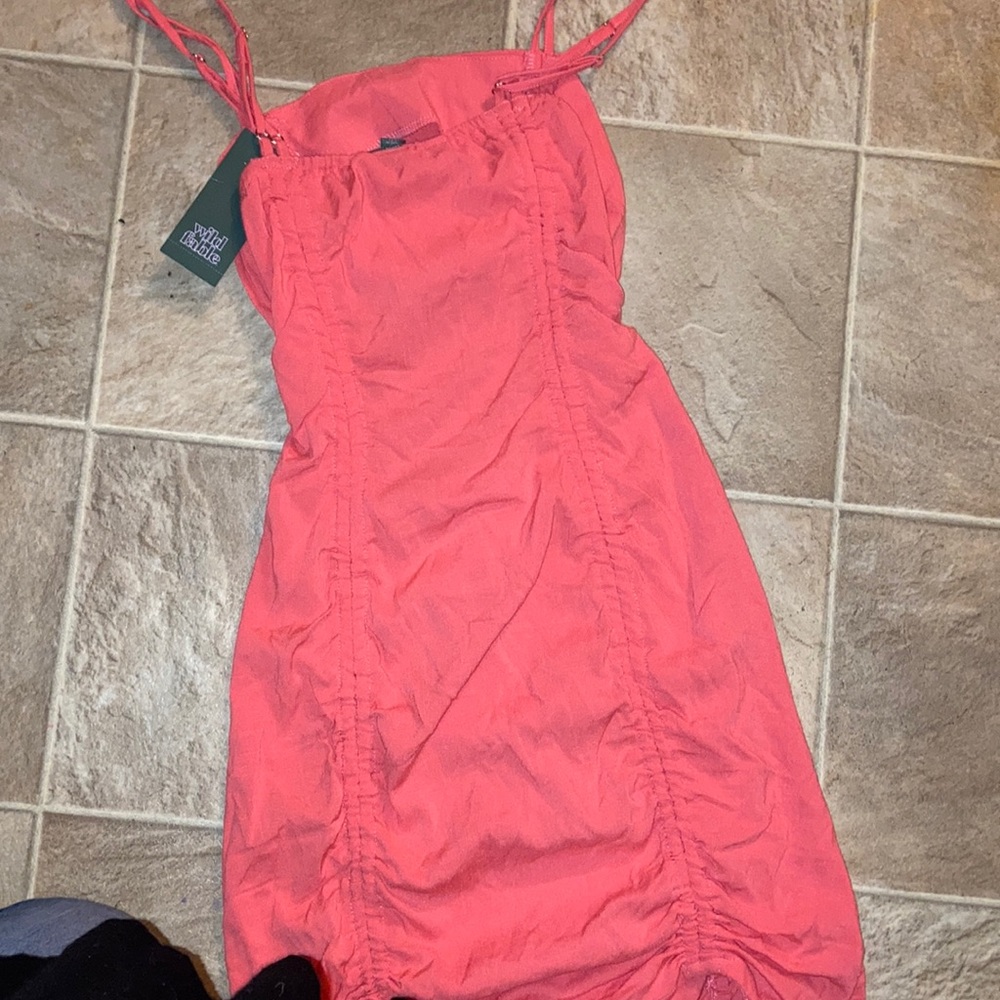Good condition it still has a tag is a spaghetti strap dress is sees in the back